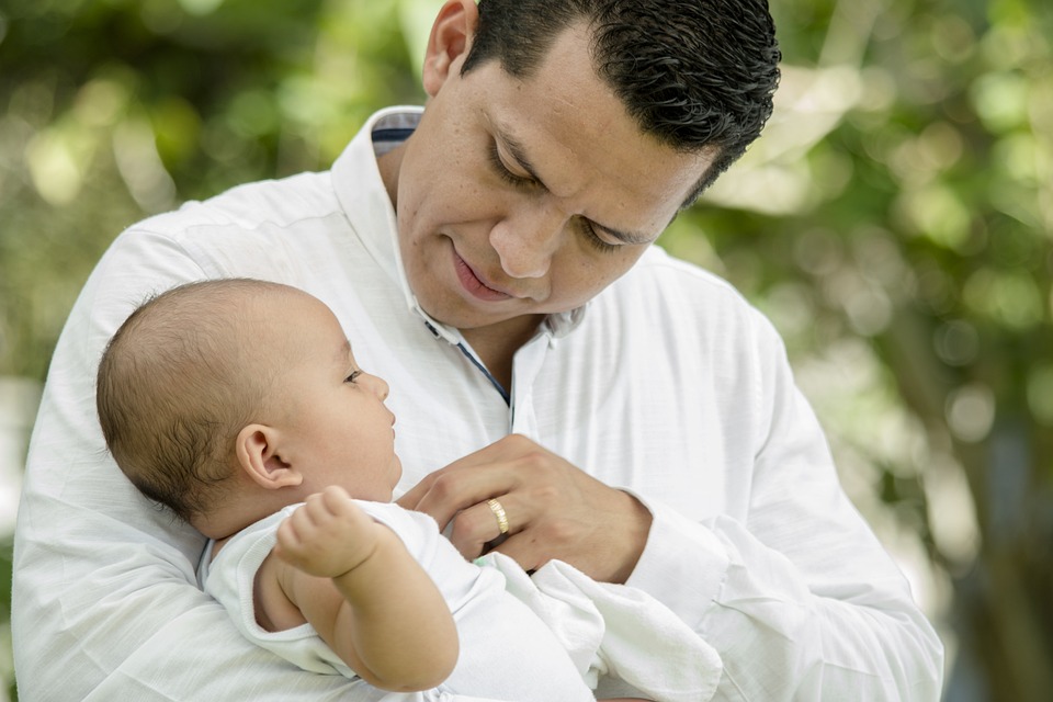 closeup image of a man holding his daughter