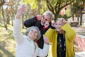 Three seniors making funny faces while taking a selfie