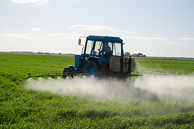 Tractor spraying pesticides.