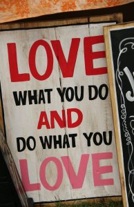 wooden sign that reads "Love what you do and do what you love."