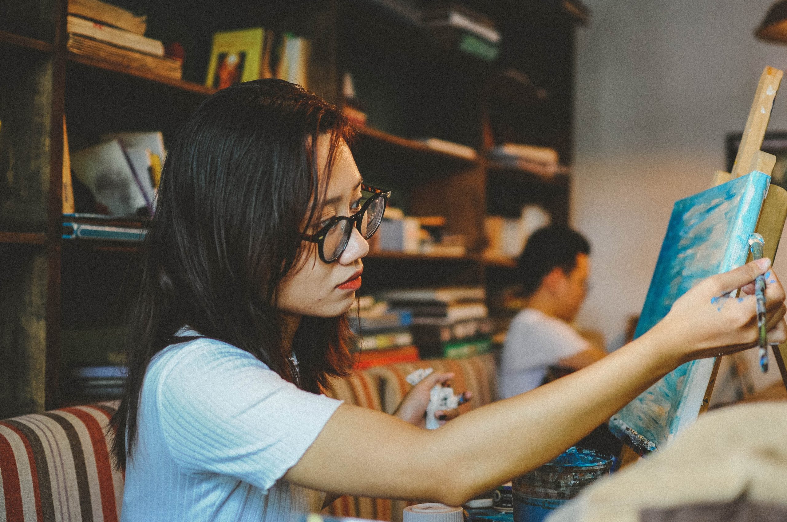 a young lady painting a picture