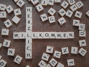 Scarbble tiles spelling Herzlich Willkommen