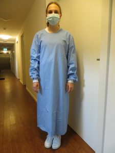 health care working in PPE including a blue gown