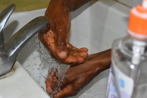image of someone washing their hands with soap and water