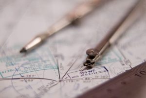 Straight scale, compasses and map