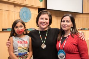 Debora Juarez standing with a mother and daughter at an event addressing Missing and Murdered Indigenous Women and Girls.