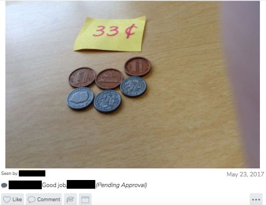 An image of plastic coins whose sum matches the amount indicated on the slip of paper (33 cents)