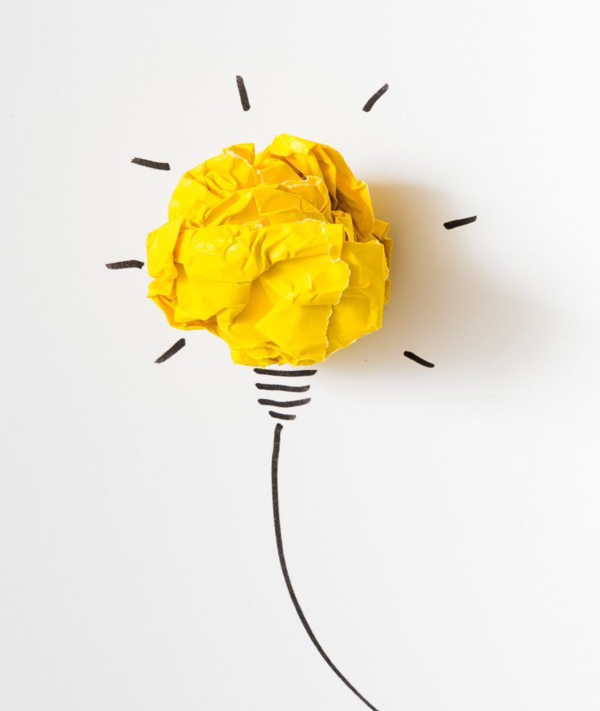 Image shows illuminated lightbulb with crumpled yellow paper used in the bulb's place and the rest drawn in black on a white background.