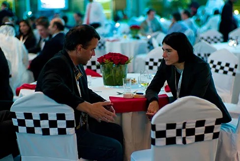 A photograph shows two people making eye contact during a conversation